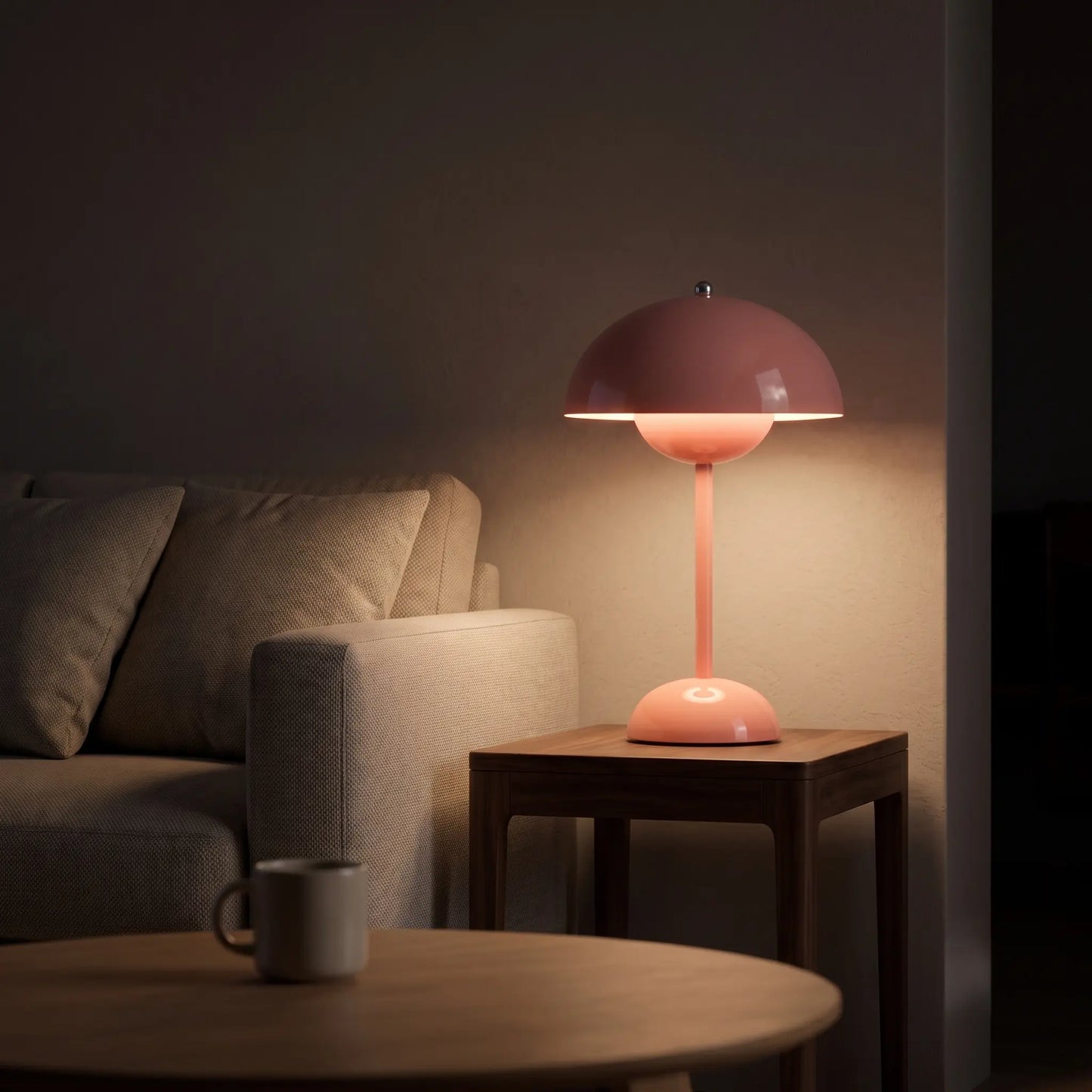 Aesthix Lume Bud pink retro table lamp glowing on a wooden side table in a cosy living room