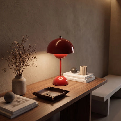 Aesthix Lume Bud red retro table lamp on a wooden console with books and dried flowers