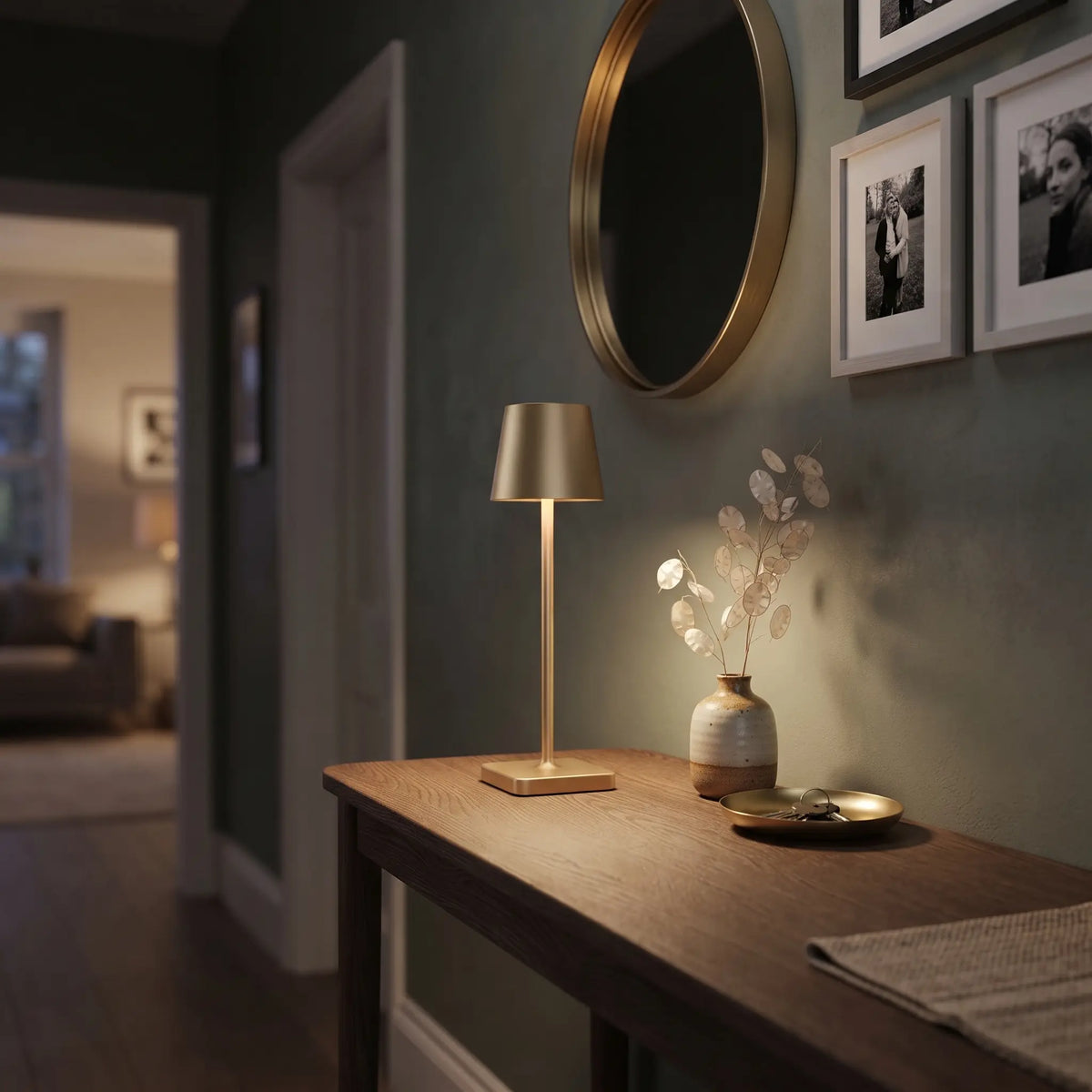 Aesthix Lume Classic gold bar style touch table lamp glowing on a console table near a mirror