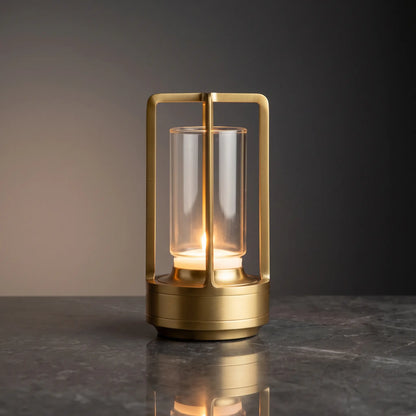 Aesthix Lume Luxe glass lantern table lamp in gold finish on a dark marble background