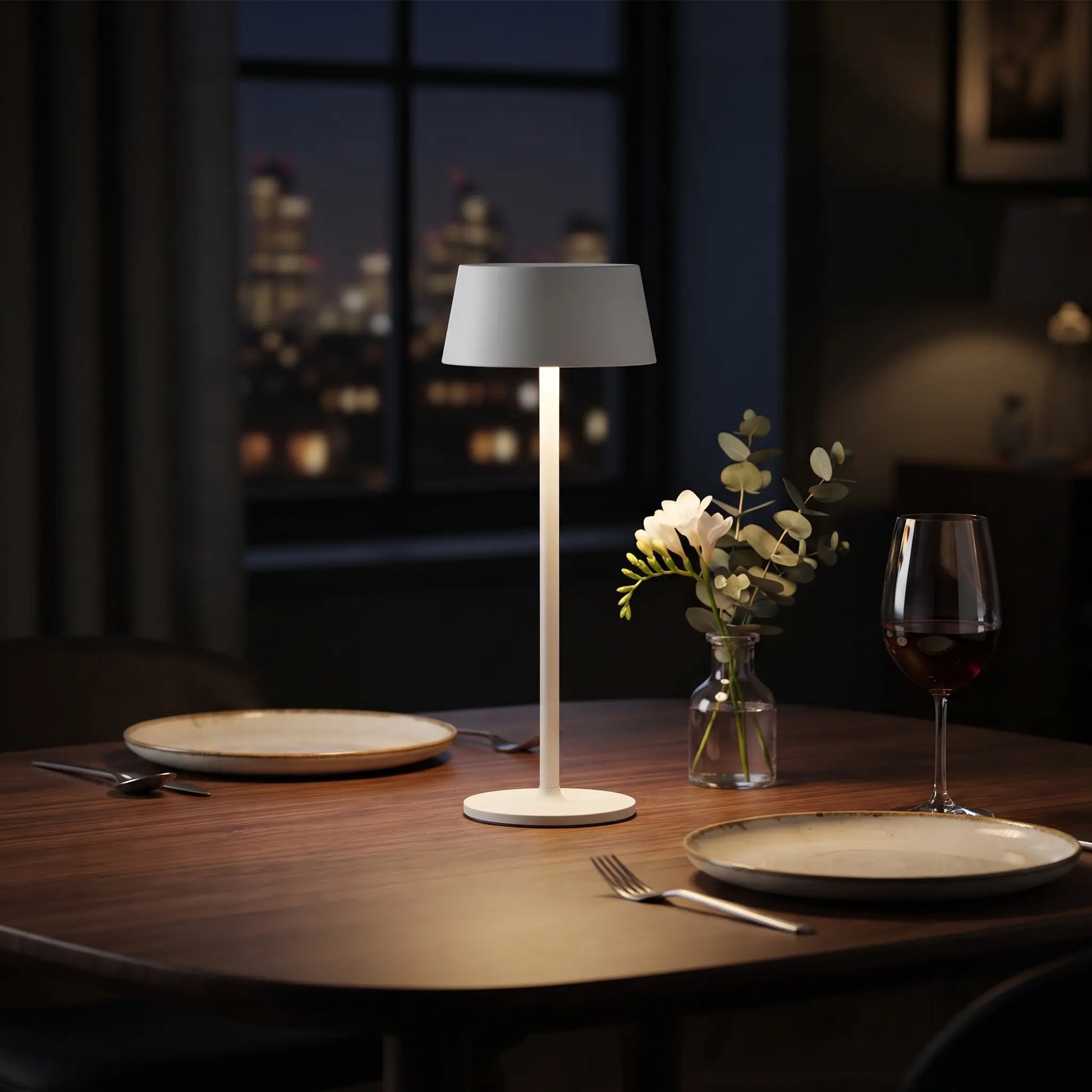 Aesthix Lume Plate white Nordic touch table lamp glowing on a dining table with flowers and wine