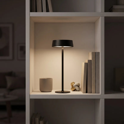 Aesthix Lume Plate black Nordic touch table lamp on a styled bookshelf with books and decor