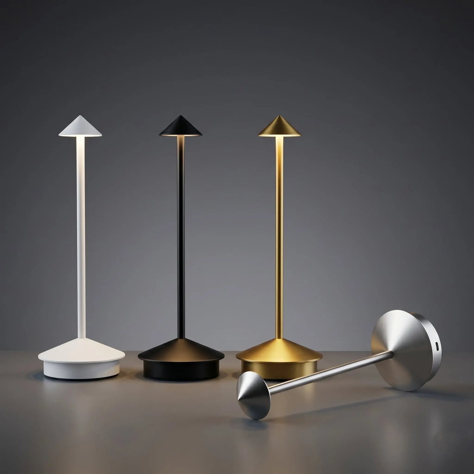 Aesthix Lume Vela slim rechargeable lamp four colour variants white black gold and silver dark background UK