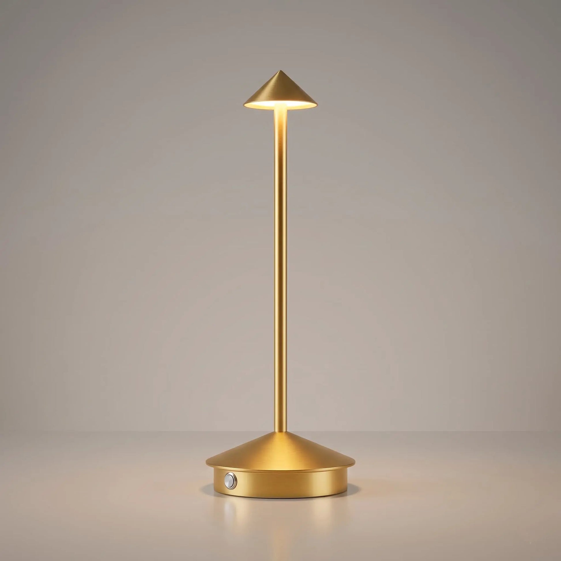 Aesthix Lume Vela slim rechargeable lamp in gold finish on plain background