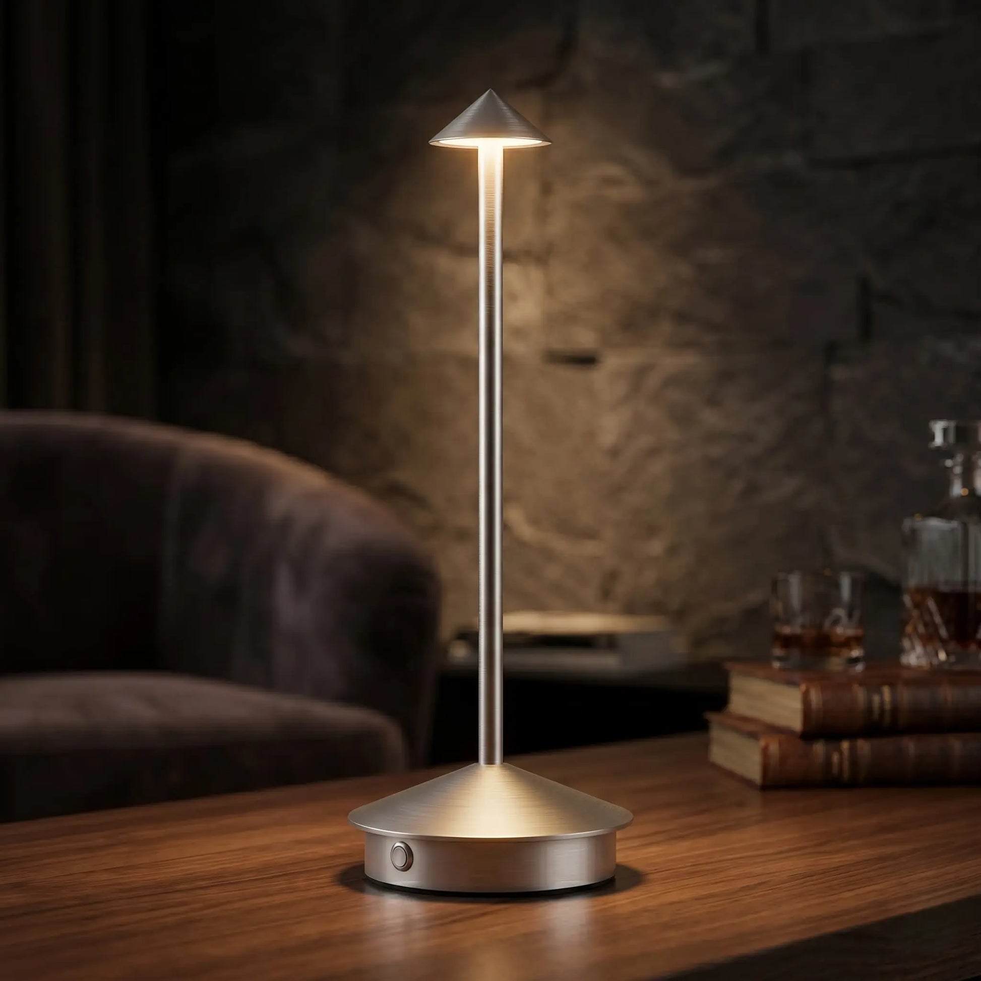 Aesthix Lume Vela silver slim rechargeable lamp glowing on a dark stone surface