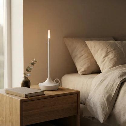 Aesthix Lume Taper candle glow lamp glowing softly on a bedside nightstand for a relaxing bedroom ambience