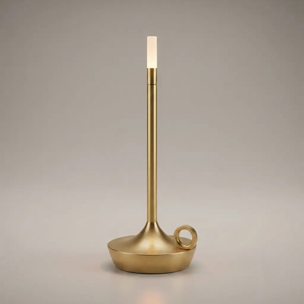 Aesthix Lume Taper candle glow lamp in brushed gold, radiating a warm flame-like glow