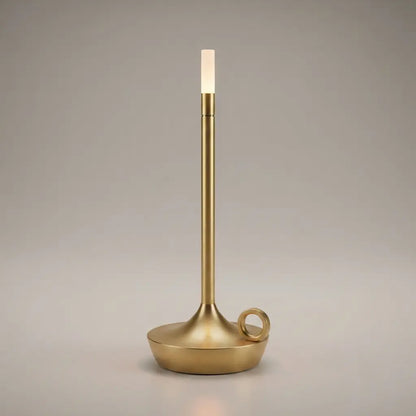 Aesthix Lume Taper candle glow lamp in brushed gold, radiating a warm flame-like glow